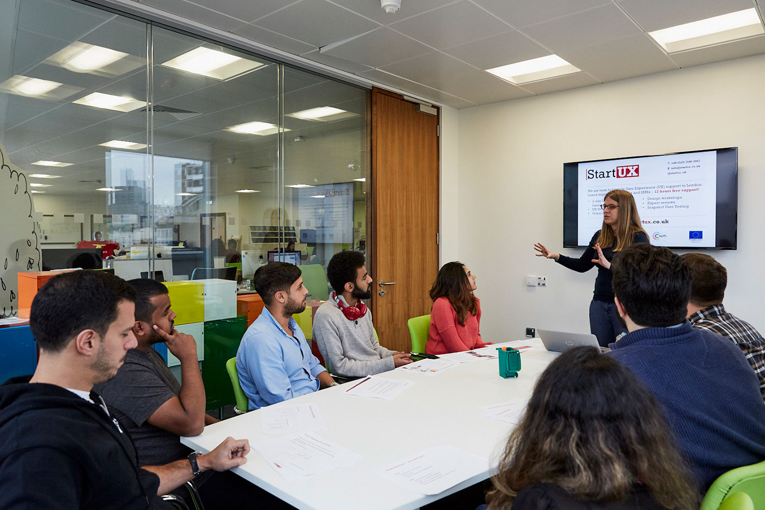 Woman addresses trainees in meeting room